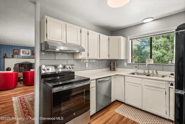 a kitchen with a sink stove and cabinets