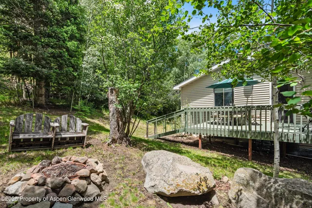 a view of a chair and table in backyard