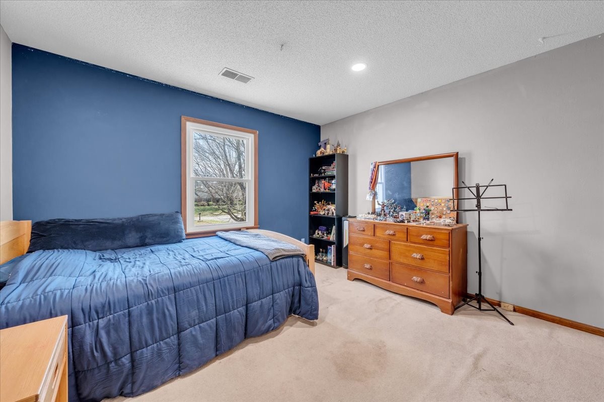 203 12 Oaks Road Tullahoma, TN 37388 - Photo 26 of 45 a bedroom with a bed and a dresser in it