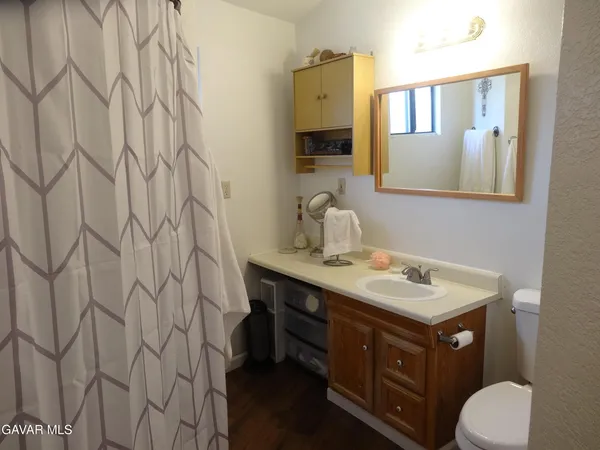a bathroom with a sink a toilet and a mirror