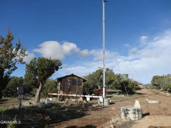 a view of a dry yard with mountains in the background