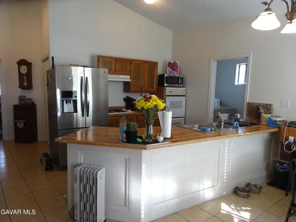 a kitchen with stainless steel appliances granite countertop a sink and a stove