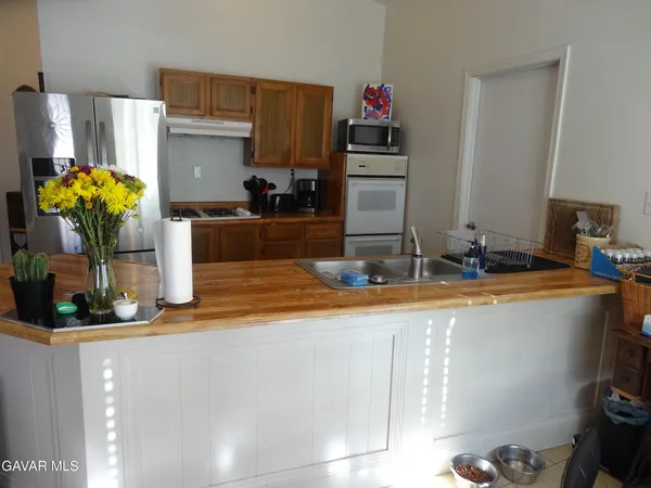 a kitchen with a sink appliances and cabinets