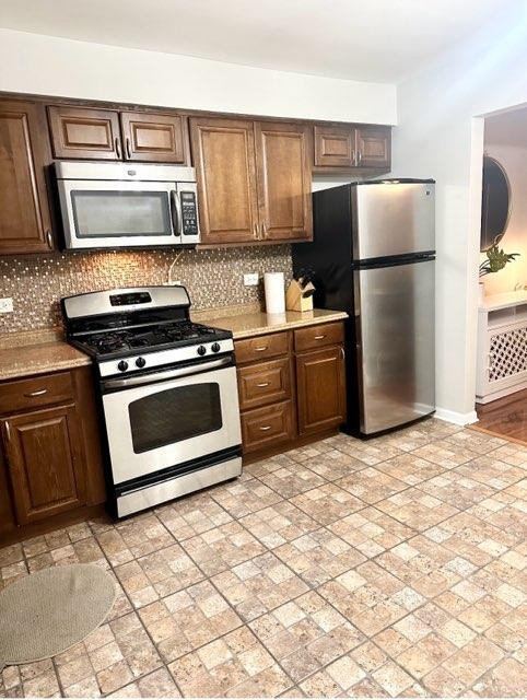 491 McHenry Road, Unit 3A Wheeling, IL 60090 - Photo 15 of 17 a kitchen with granite countertop a refrigerator stove and microwave