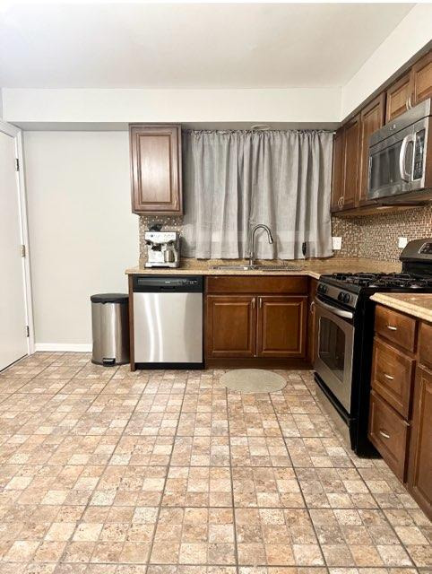 491 McHenry Road, Unit 3A Wheeling, IL 60090 - Photo 17 of 17 a kitchen with stainless steel appliances granite countertop a stove a sink and a microwave