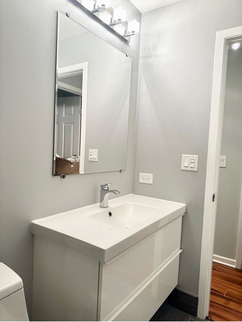 491 McHenry Road, Unit 3A Wheeling, IL 60090 - Photo 5 of 17 a bathroom with a sink and a mirror