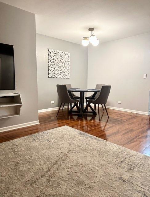 491 McHenry Road, Unit 3A Wheeling, IL 60090 - Photo 8 of 17 a view of a dining room with furniture and wooden floor
