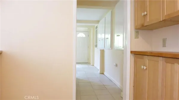 a kitchen with a sink a stove cabinets and a window