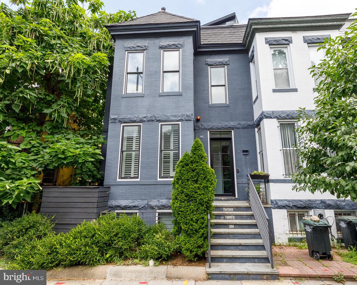 1321 Monroe Street Northwest, Unit PH Washington, DC 20010 - Photo 1 of 40 a front view of a house with a garden