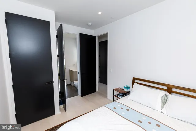 a living room with a bed and a walk in closet