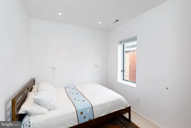 a bed room with a bed and a window