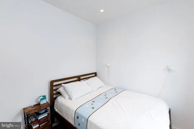 a utility room with a bed and a window