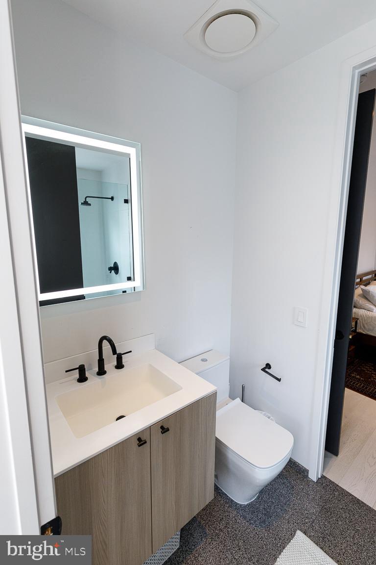 1321 Monroe Street Northwest, Unit PH Washington, DC 20010 - Photo 15 of 40 a bathroom with a sink and a mirror