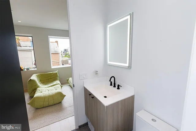 a bedroom with a sink and a window