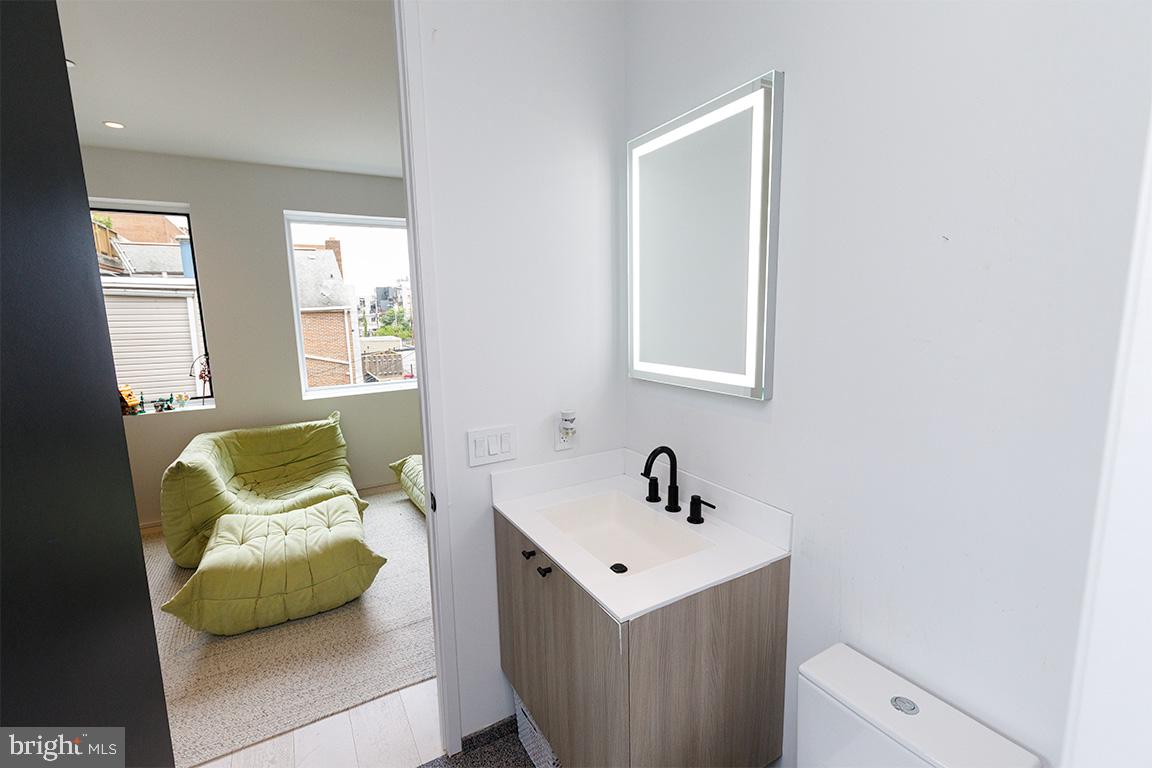 1321 Monroe Street Northwest, Unit PH Washington, DC 20010 - Photo 17 of 40 a bedroom with a sink and a window