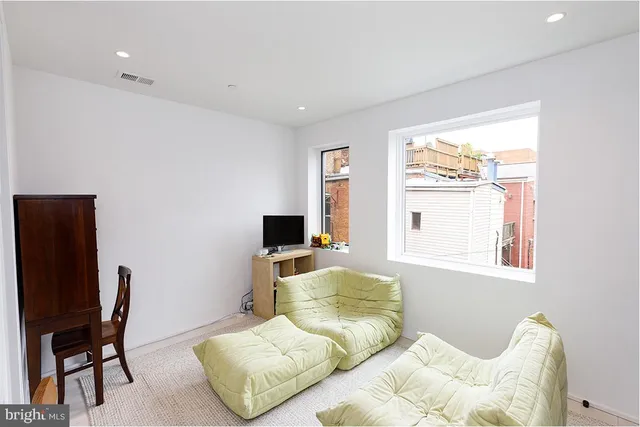 a bedroom with a bed and a chair