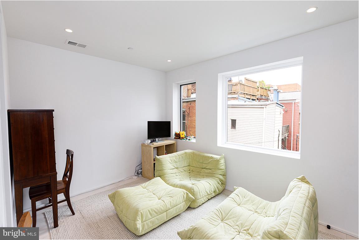 1321 Monroe Street Northwest, Unit PH Washington, DC 20010 - Photo 18 of 40 a bedroom with a bed and a chair