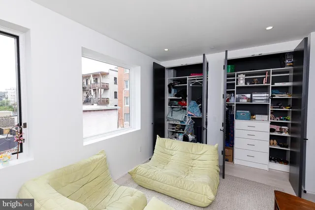 a bedroom with furniture and a book shelf