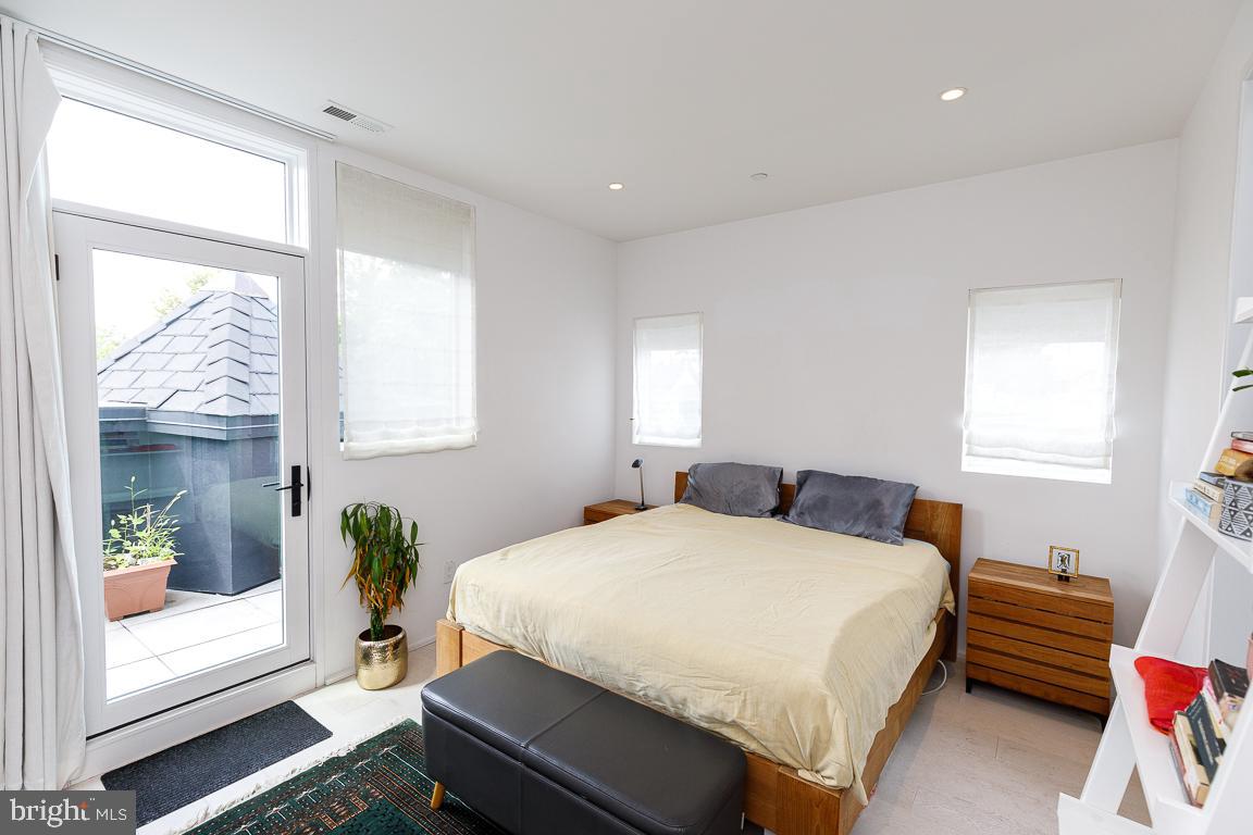 1321 Monroe Street Northwest, Unit PH Washington, DC 20010 - Photo 23 of 40 a bedroom with a bed and wooden floor