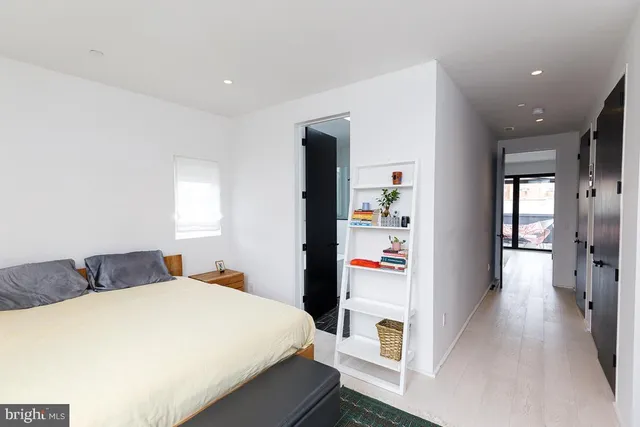 a bedroom with a bed and a large mirror