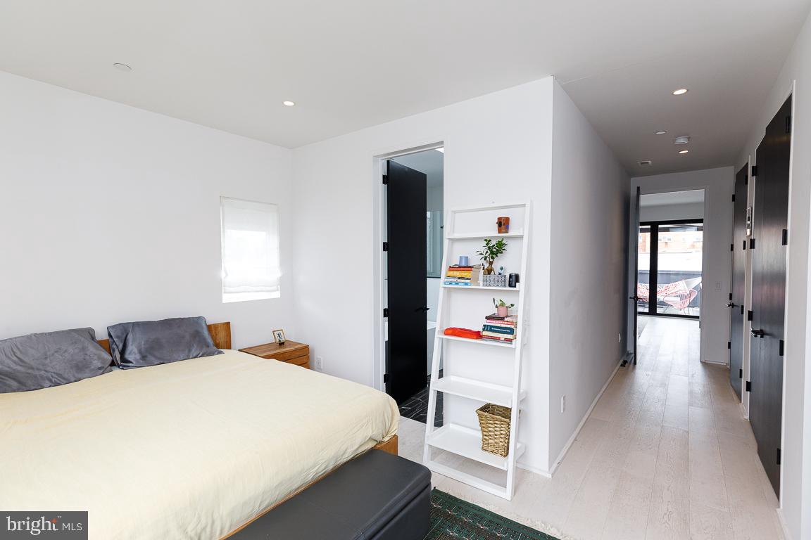 1321 Monroe Street Northwest, Unit PH Washington, DC 20010 - Photo 24 of 40 a bedroom with a bed and a large mirror