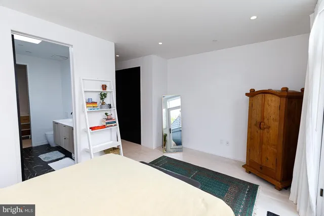 a bedroom with a bed and a mirror