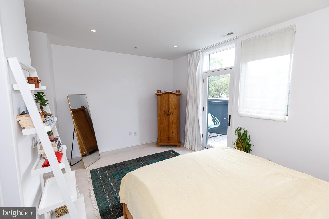 1321 Monroe Street Northwest, Unit PH Washington, DC 20010 - Photo 26 of 40 a bedroom with a bed and a flat tv screen on the dresser