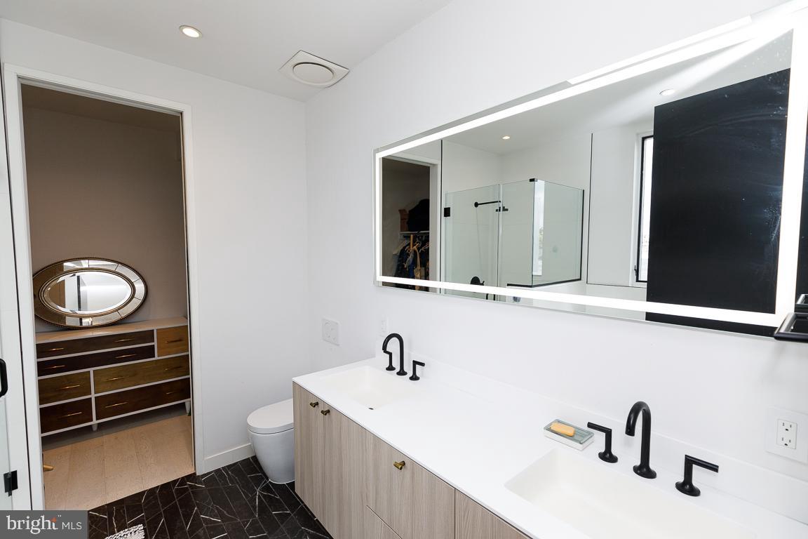 1321 Monroe Street Northwest, Unit PH Washington, DC 20010 - Photo 27 of 40 a bathroom with a sink and a mirror