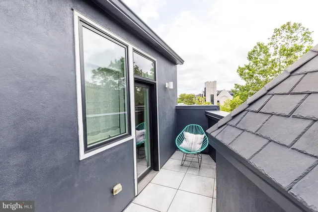 a couple of potted plants sitting in front of a door