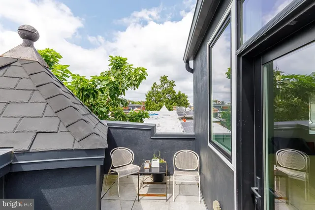 a room with furniture and a floor to ceiling window