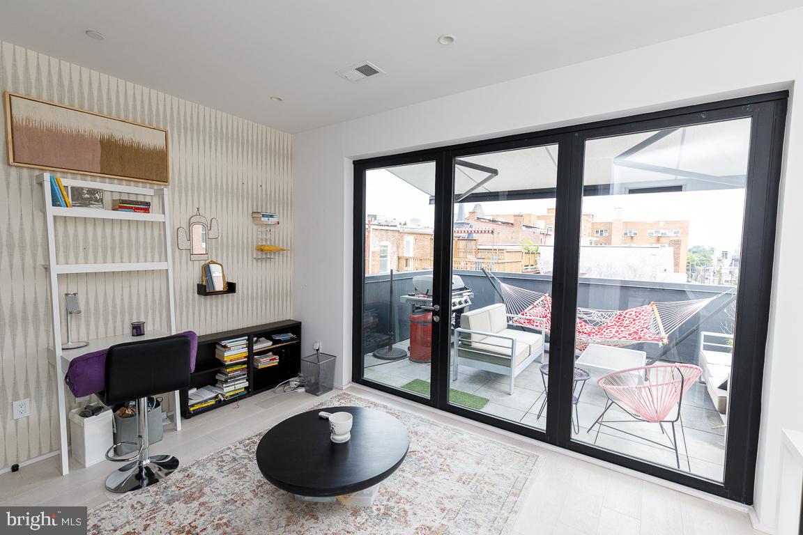 1321 Monroe Street Northwest, Unit PH Washington, DC 20010 - Photo 34 of 40 a room with furniture and a floor to ceiling window