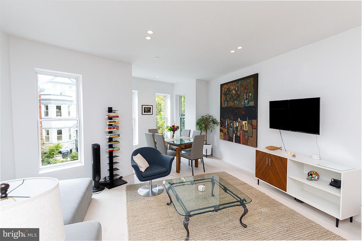 1321 Monroe Street Northwest, Unit PH Washington, DC 20010 - Photo 4 of 40 a living room with furniture and a flat screen tv