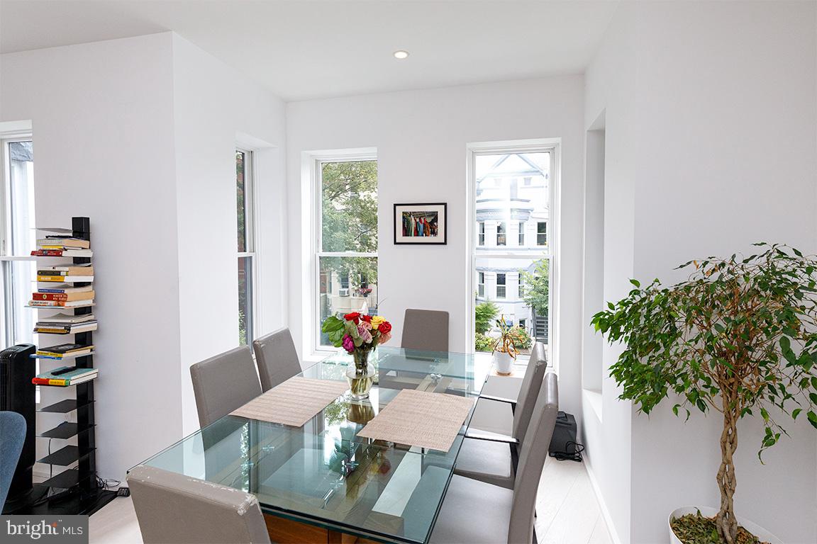 1321 Monroe Street Northwest, Unit PH Washington, DC 20010 - Photo 8 of 40 a view of a dining room with furniture window and flowerpot