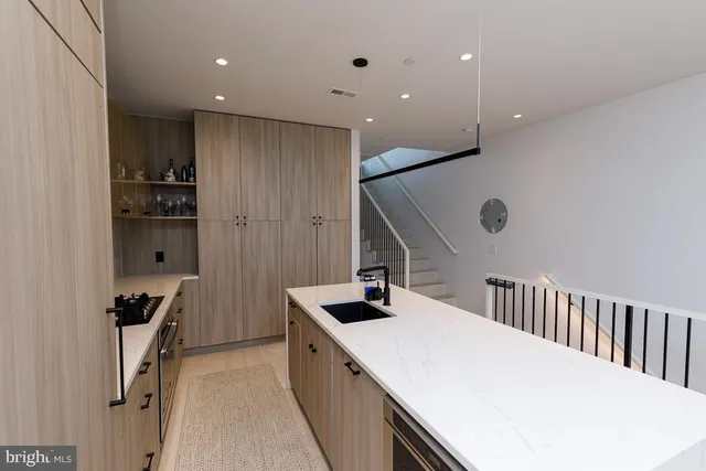 a kitchen with kitchen island stainless steel appliances sink refrigerator and stove