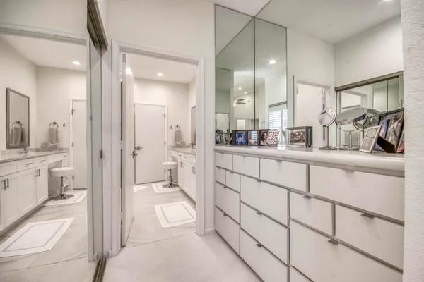 a bathroom with a granite countertop sink mirror vanity and toilet