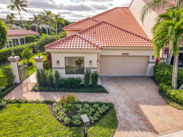 an aerial view of a house with a garden and lake view