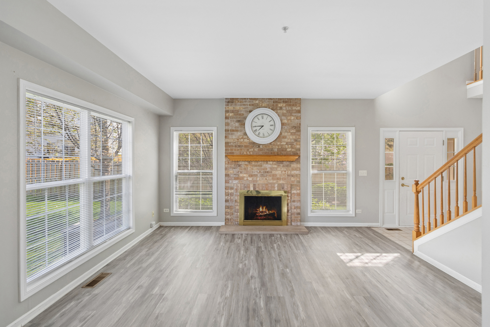 2075 Ivy Ridge Drive Hoffman Estates, IL 60192 - Photo 3 of 20 a view of empty room with wooden floor and fireplace
