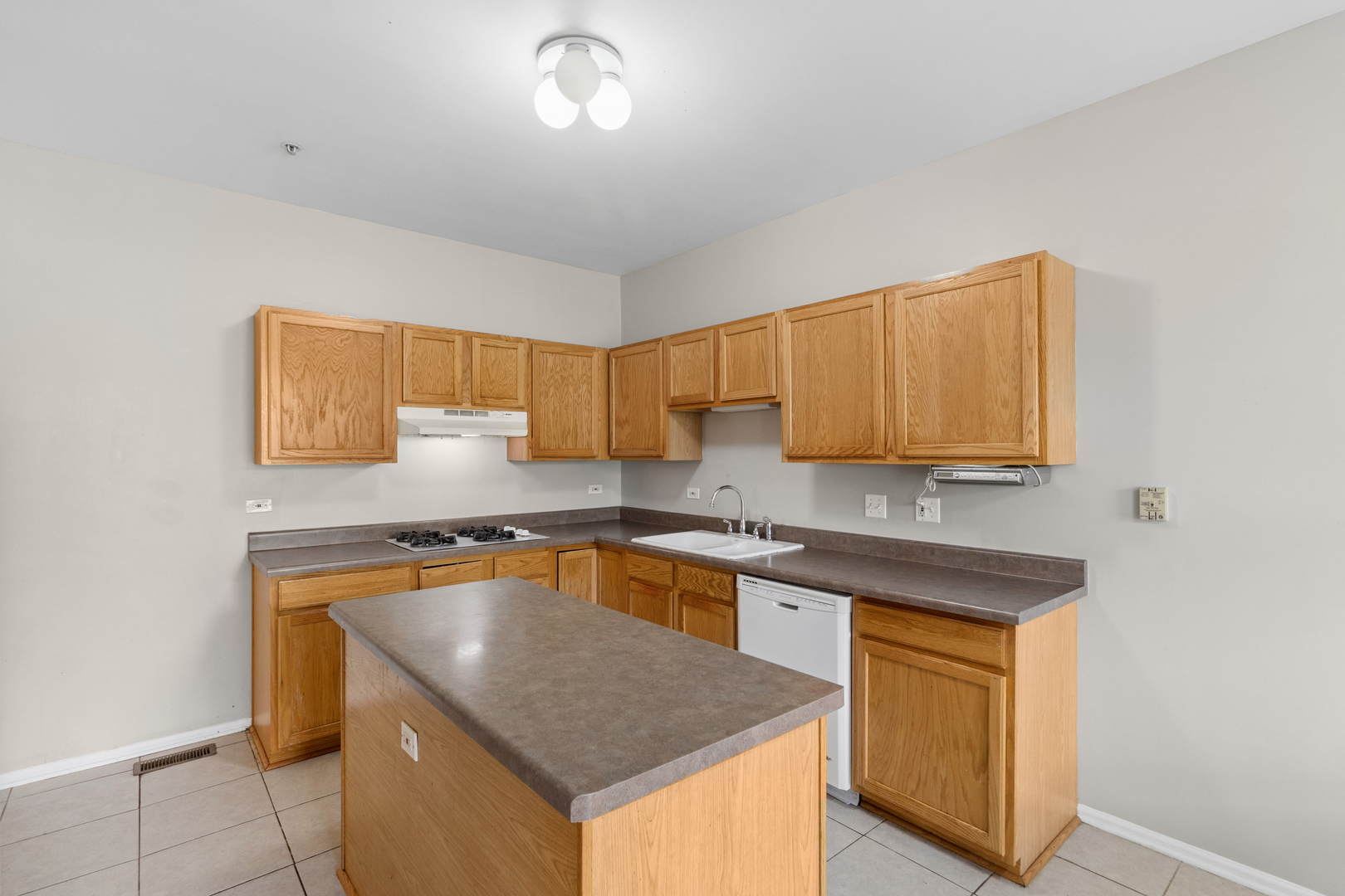 2075 Ivy Ridge Drive Hoffman Estates, IL 60192 - Photo 7 of 20 a kitchen with stainless steel appliances granite countertop a sink stove and cabinets