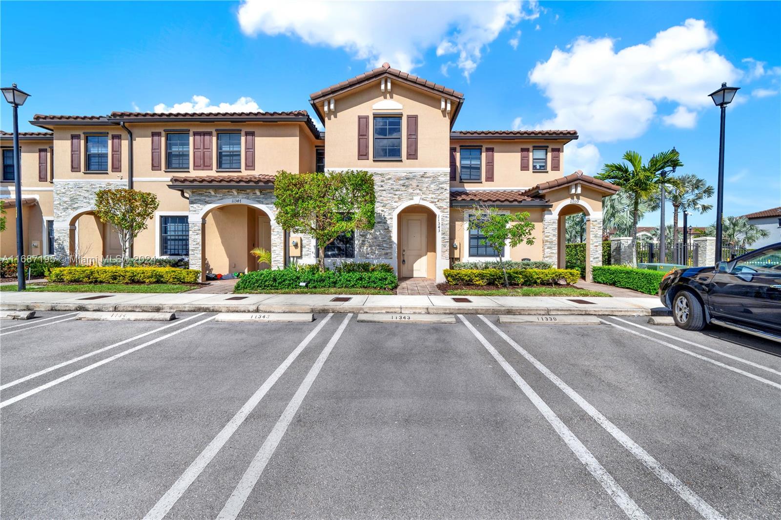 11343 Southwest 250th Terrace, Unit 11343 Homestead, FL 33032 - Photo 1 of 37 a front view of a house with a yard and garage