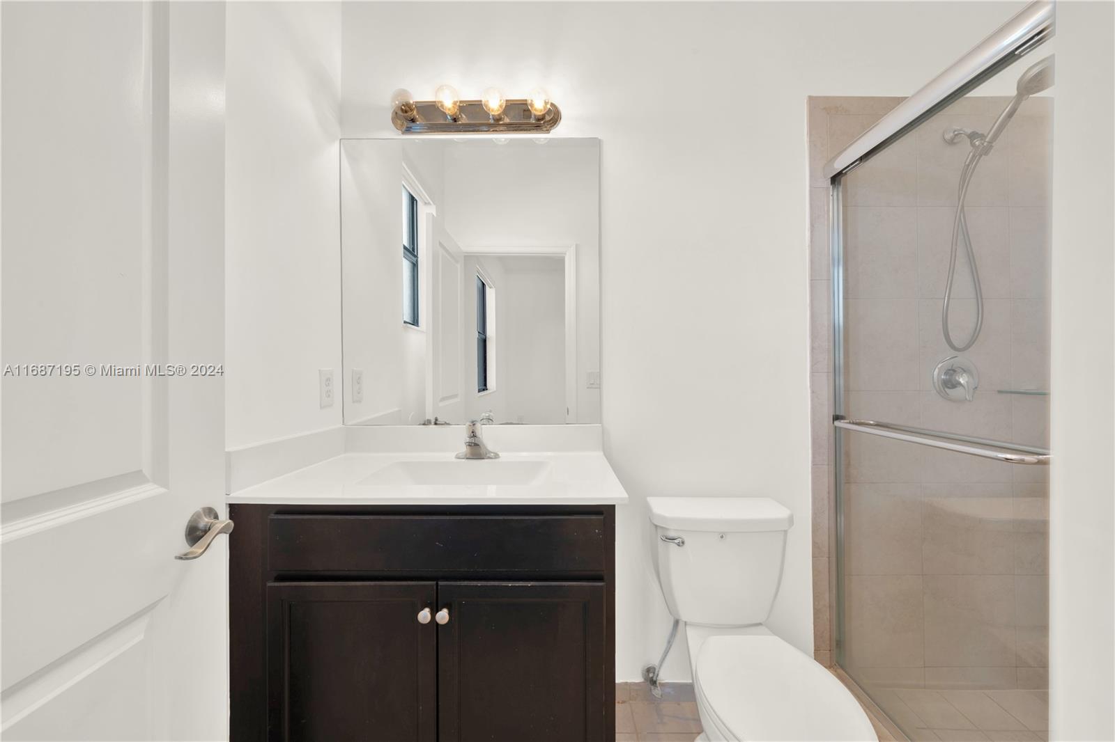 11343 Southwest 250th Terrace, Unit 11343 Homestead, FL 33032 - Photo 20 of 37 a bathroom with a sink a toilet and shower