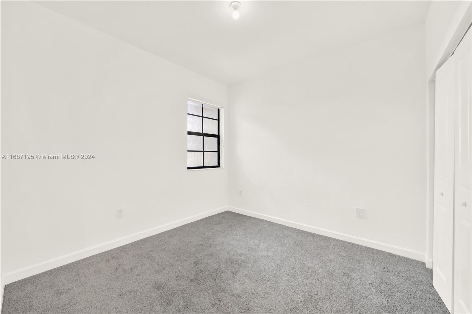 11343 Southwest 250th Terrace, Unit 11343 Homestead, FL 33032 - Photo 21 of 37 an empty room with windows