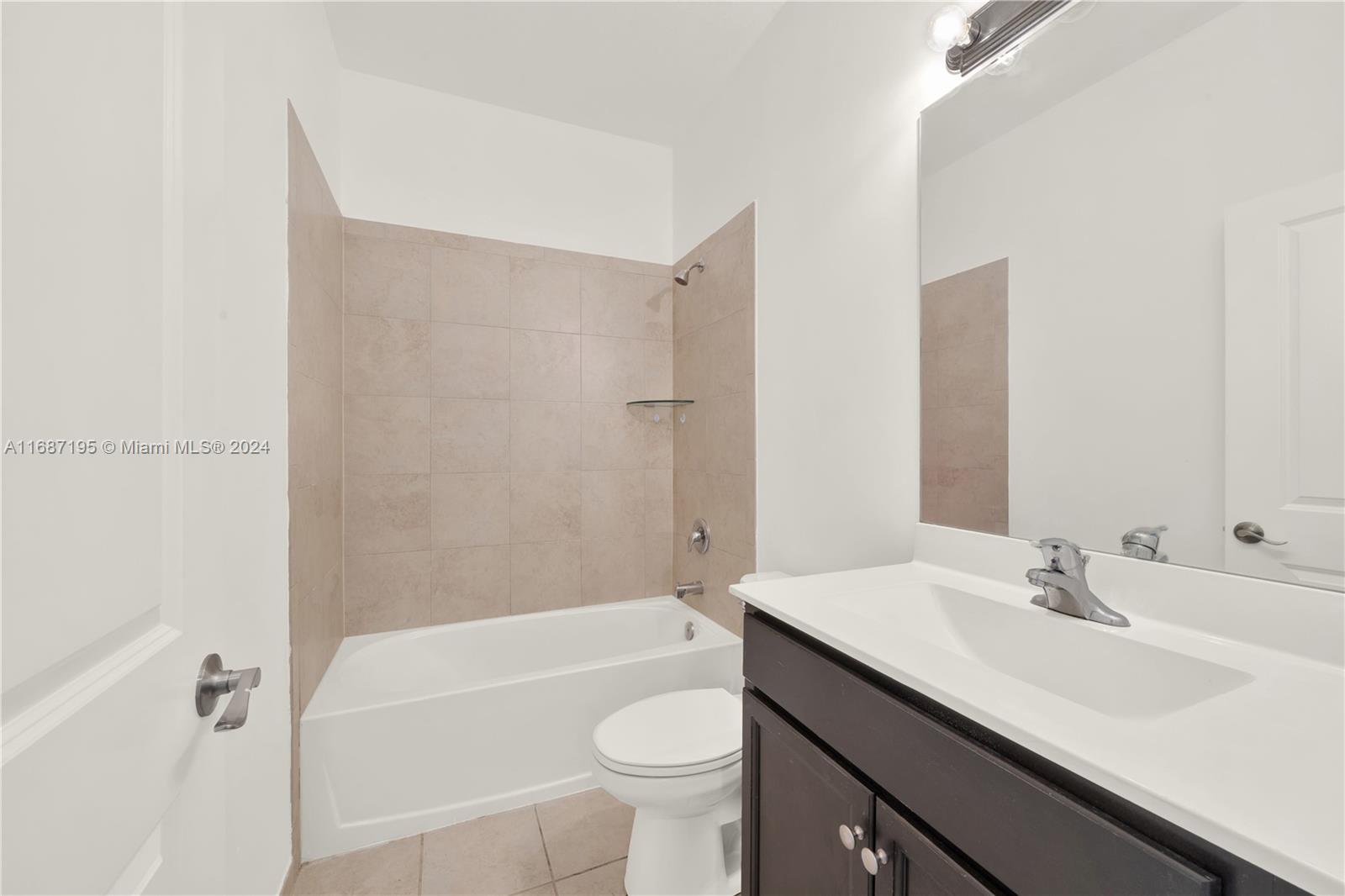 11343 Southwest 250th Terrace, Unit 11343 Homestead, FL 33032 - Photo 22 of 37 a bathroom with a sink a toilet and shower