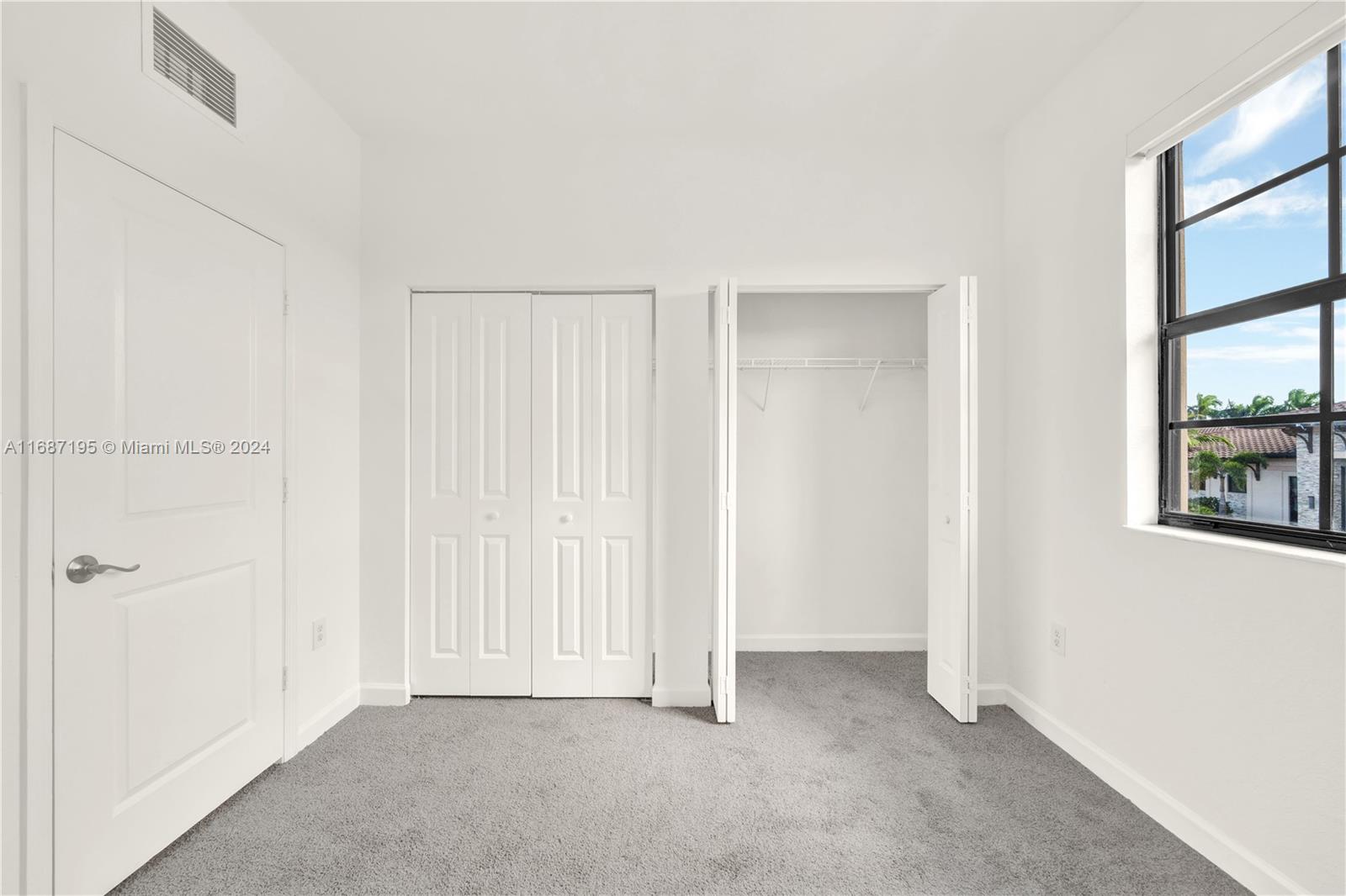 11343 Southwest 250th Terrace, Unit 11343 Homestead, FL 33032 - Photo 25 of 37 an empty room with windows