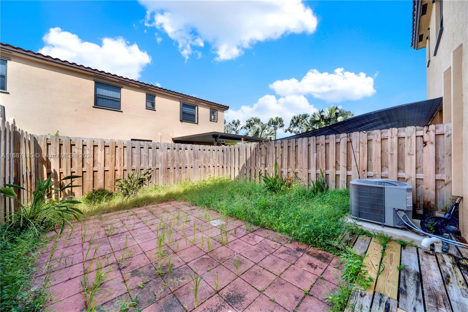 11343 Southwest 250th Terrace, Unit 11343 Homestead, FL 33032 - Photo 26 of 37 a view of a backyard with plants