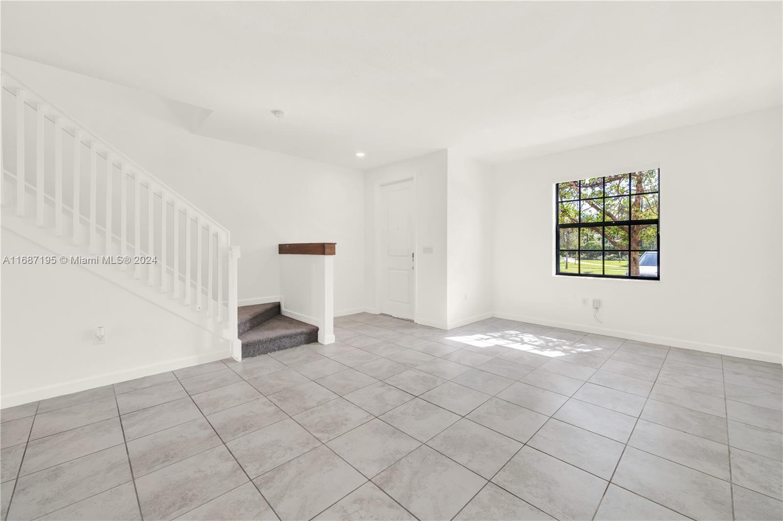11343 Southwest 250th Terrace, Unit 11343 Homestead, FL 33032 - Photo 5 of 37 an empty room with windows and closet