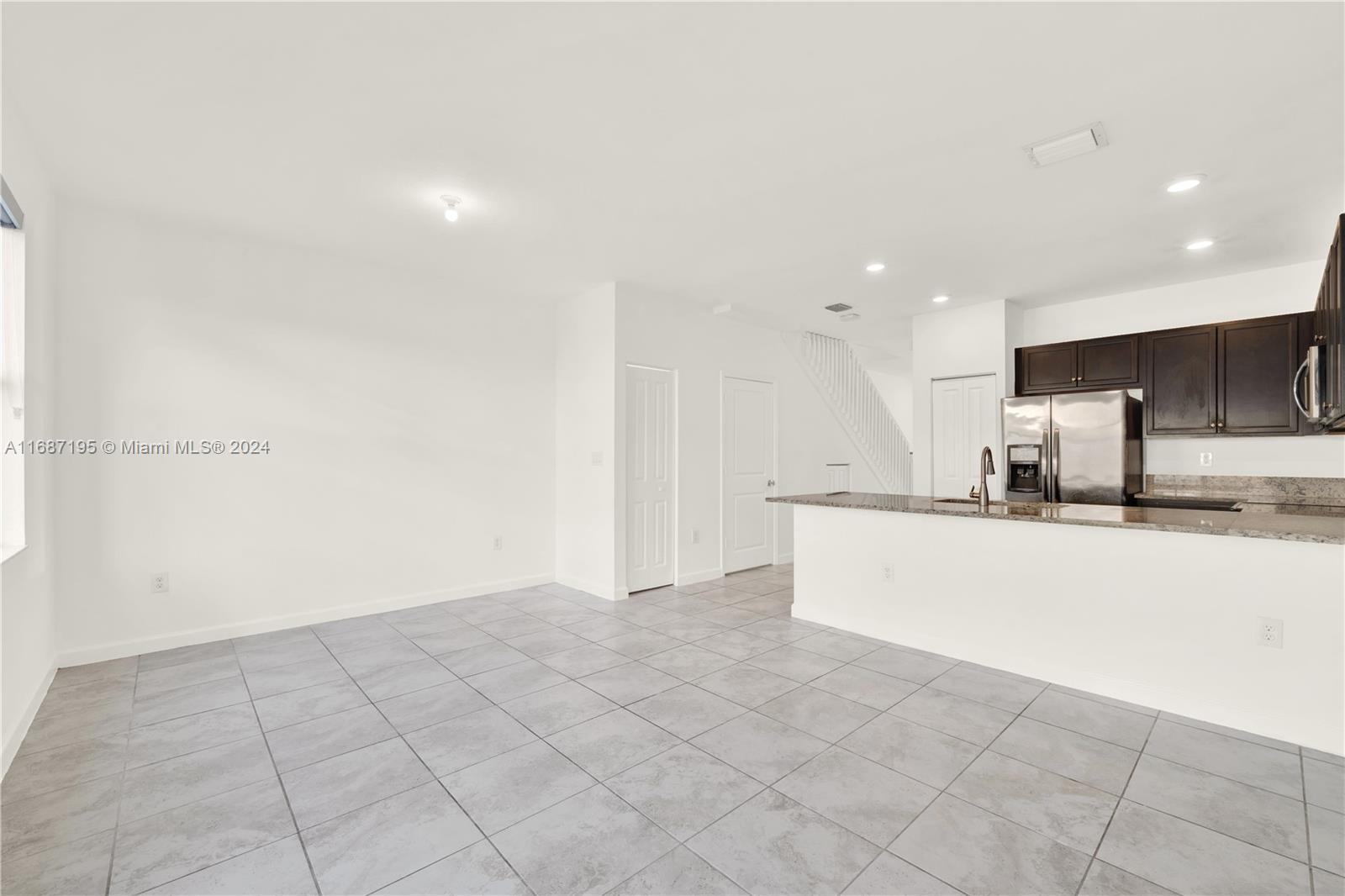 11343 Southwest 250th Terrace, Unit 11343 Homestead, FL 33032 - Photo 9 of 37 a view of kitchen with granite countertop cabinets and sink