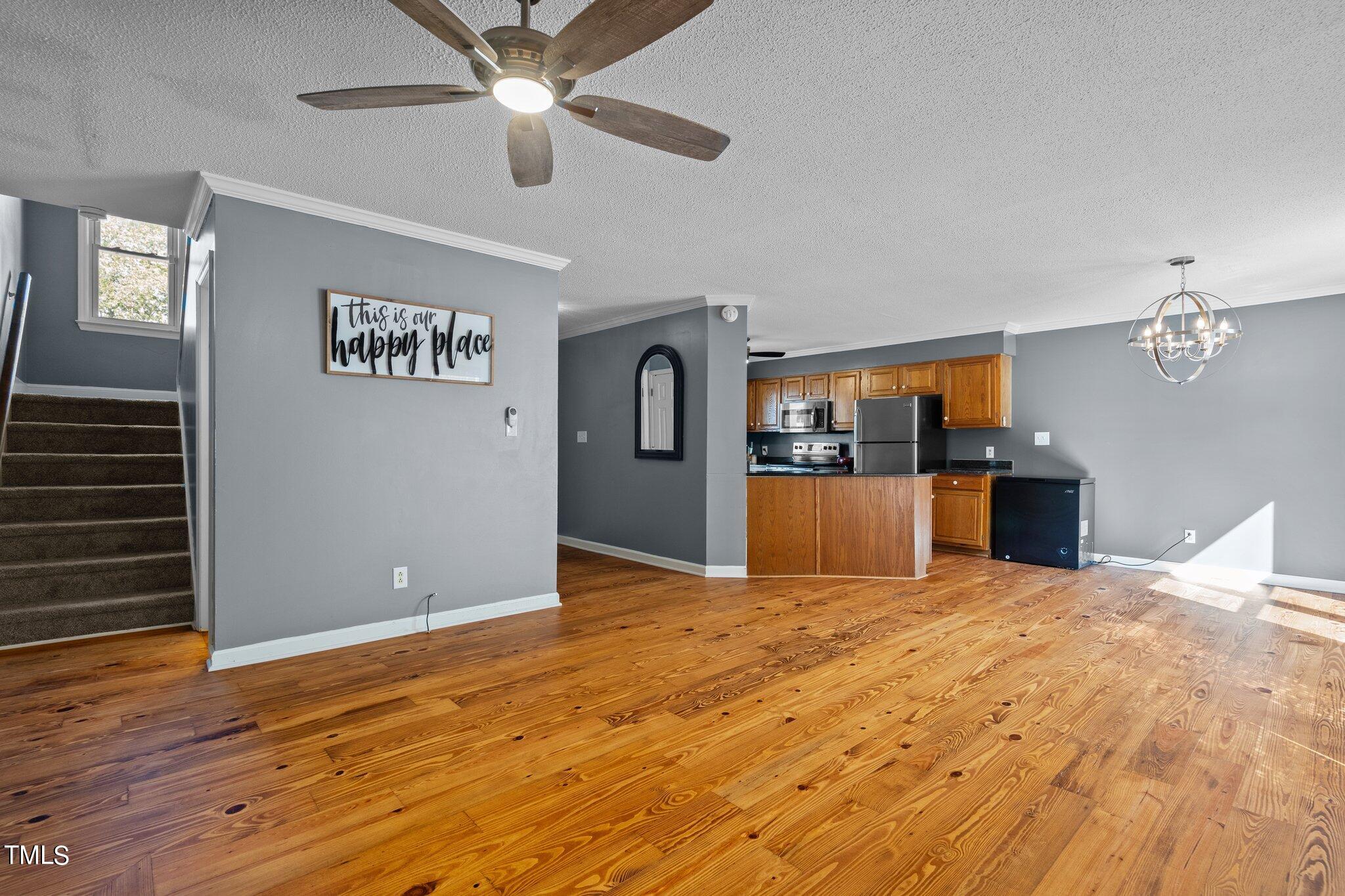 3520 Rawdon Drive Durham, NC 27713 - Photo 12 of 30 a view of a livingroom with a furniture ceiling fan and window