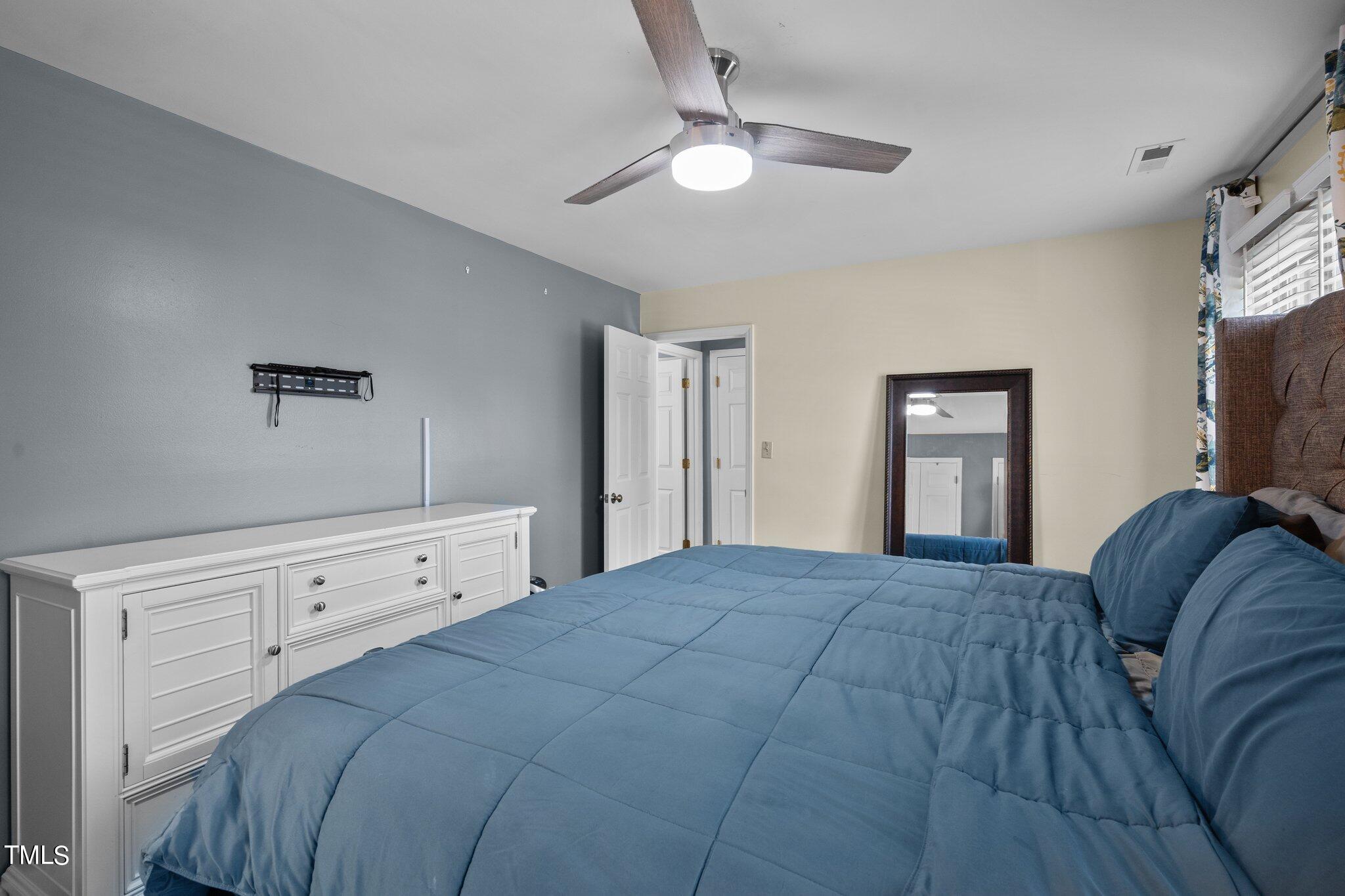 3520 Rawdon Drive Durham, NC 27713 - Photo 17 of 30 a bedroom with a bed and a tv on dresser