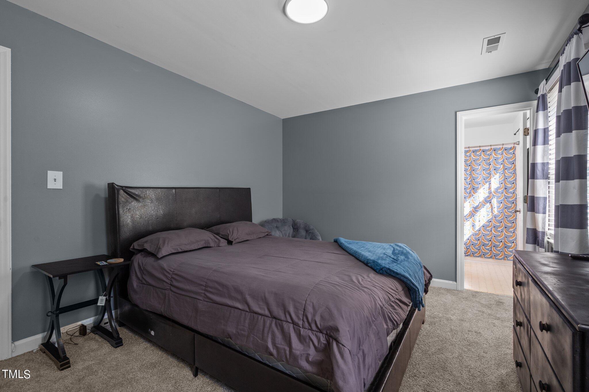 3520 Rawdon Drive Durham, NC 27713 - Photo 20 of 30 a bedroom with a bed and a tv on the dresser