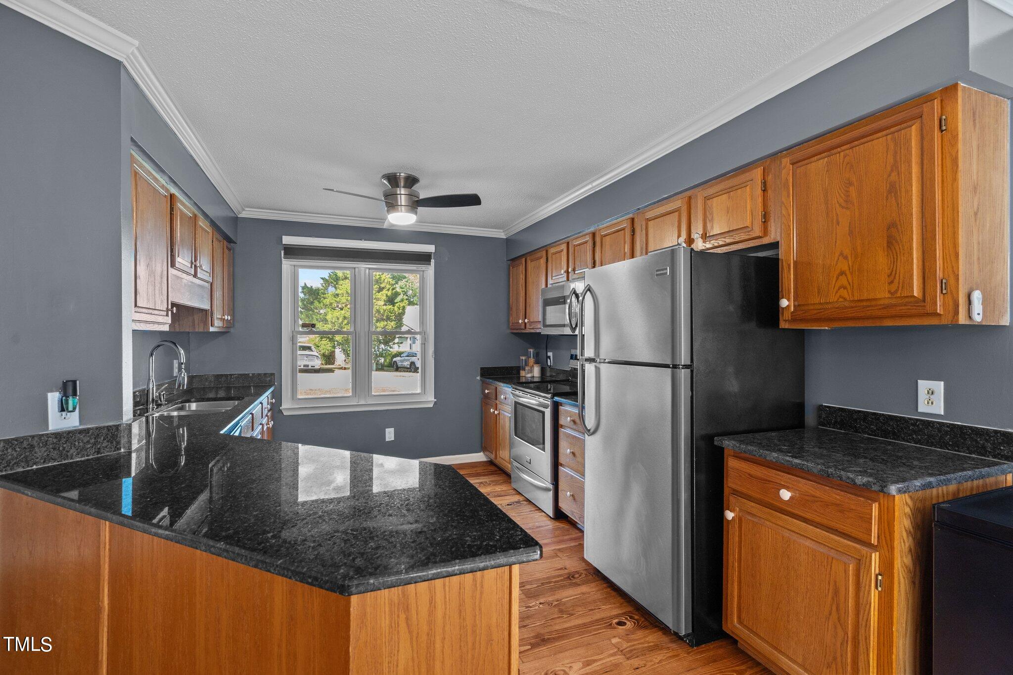 3520 Rawdon Drive Durham, NC 27713 - Photo 7 of 30 a kitchen with stainless steel appliances granite countertop a refrigerator a stove a sink a counter space and cabinets